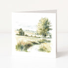 Greeting card with a watercolor landscape of trees and fields on a white background