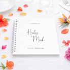 Personalized guestbook with floral decorations on a white surface