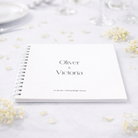 Guestbook with 'Oliver & Victoria' on a light background with flowers