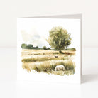 Greeting card with a scenic illustration of a field and tree on a white background