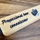 wooden bottle opener with professional beer connoisseur printed on the handle up close