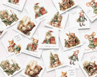 A scattered arrangement of vintage-style Christmas greeting cards featuring illustrated animals such as rabbits, mice, a squirrel, and a goose around Christmas trees, gifts, and cozy holiday scenes on a white background.
