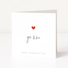 Valentine's Day card with a red heart and 'you & me' text on a white background
