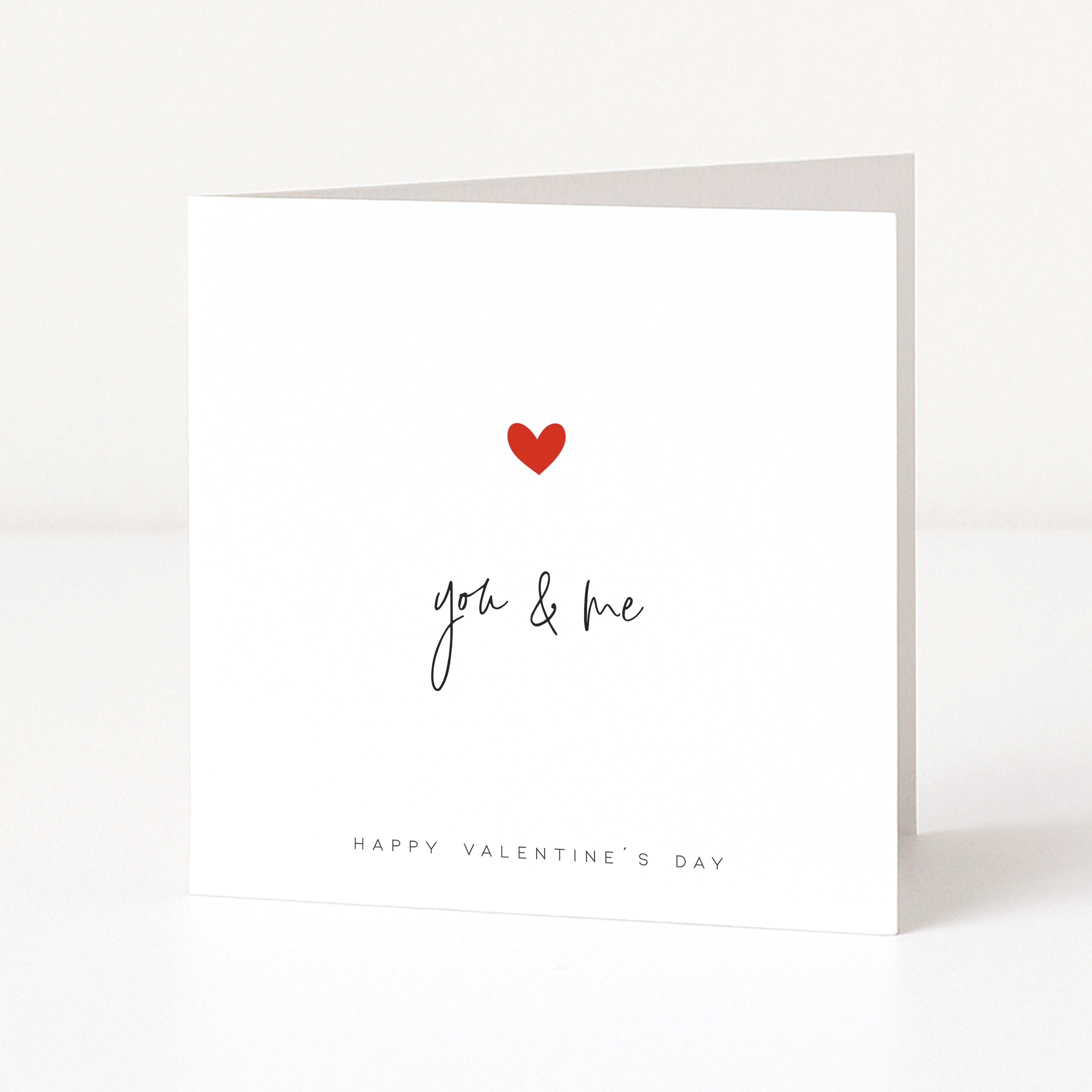 Valentine's Day card with a red heart and 'you & me' text on a white background