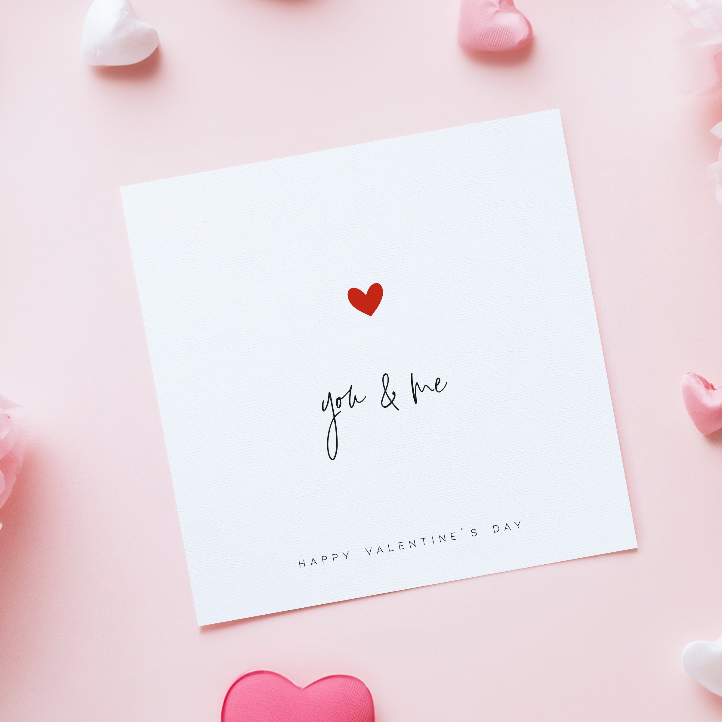 Valentine's Day card with 'you & me' and a heart on a pink background