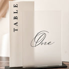 Table number sign with 'TABLE One' on a wooden surface