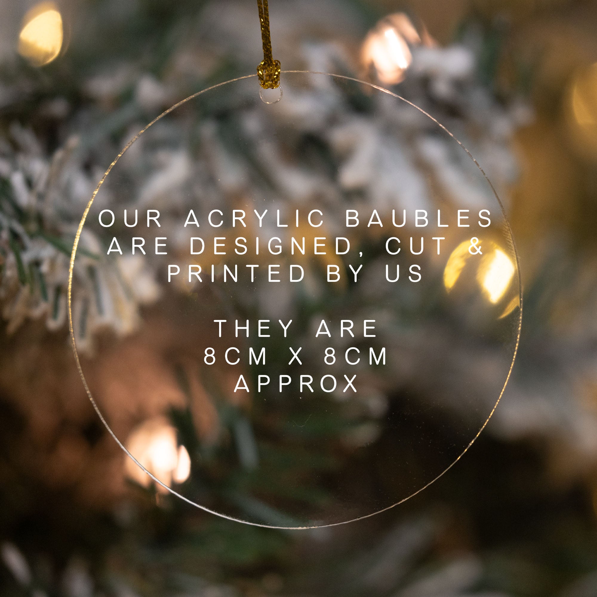 Clear acrylic Christmas ornament with text overlay on a blurred Christmas tree background