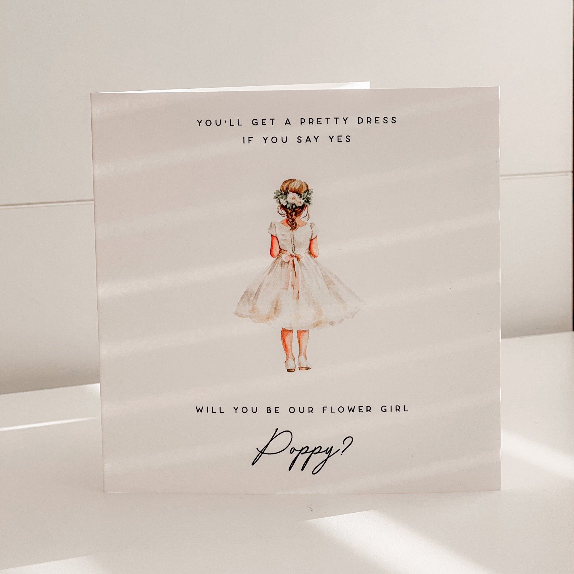 Card with illustration of a girl in a flower girl dress and text on a white background