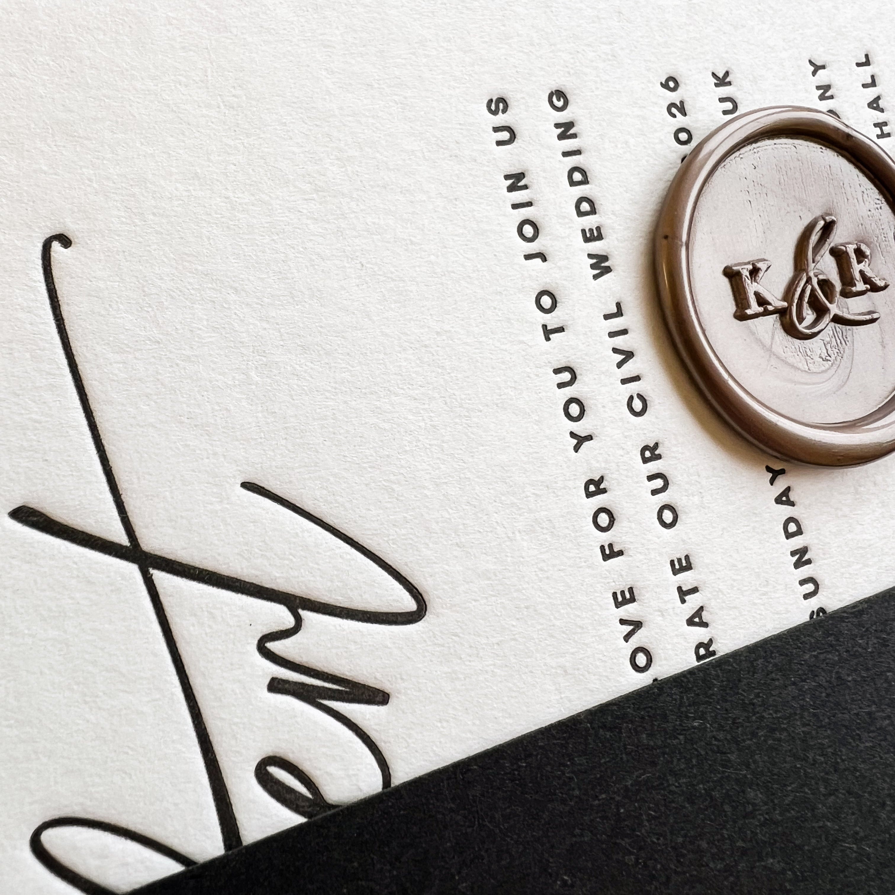 Letterpress Wedding invitation card with wax seal and text on a neutral background