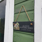 Sign on a potting shed door with 'Alice's Potting Shed' text