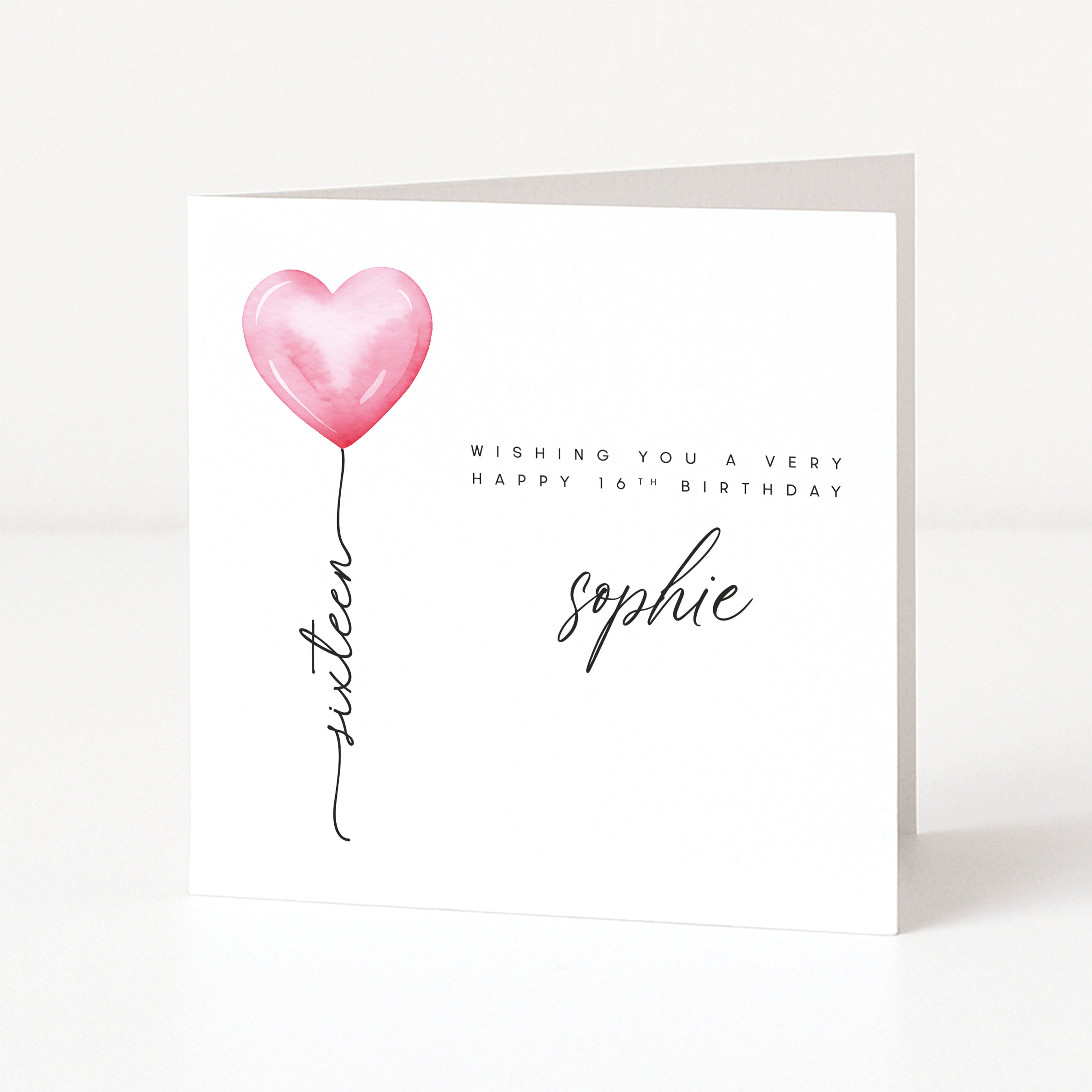 Greeting card with pink heart balloon and birthday wishes on a white background