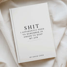 white a5 notebooks with "shit i need to remember in order to keep my job" printed on the front.
