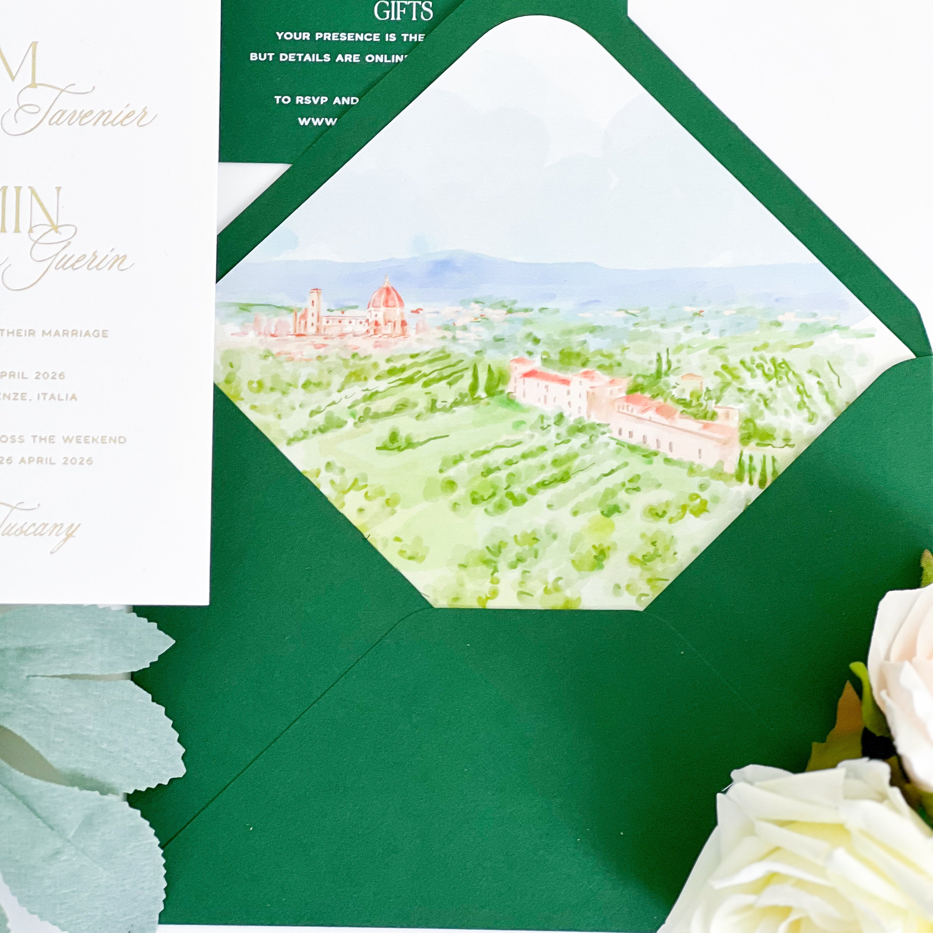 Green envelope with a scenic illustration of a Tuscan landscape and white roses.